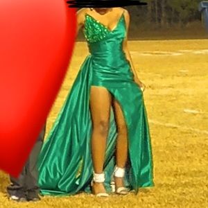 Emerald green dress with high slit, long train, and a laced up back.